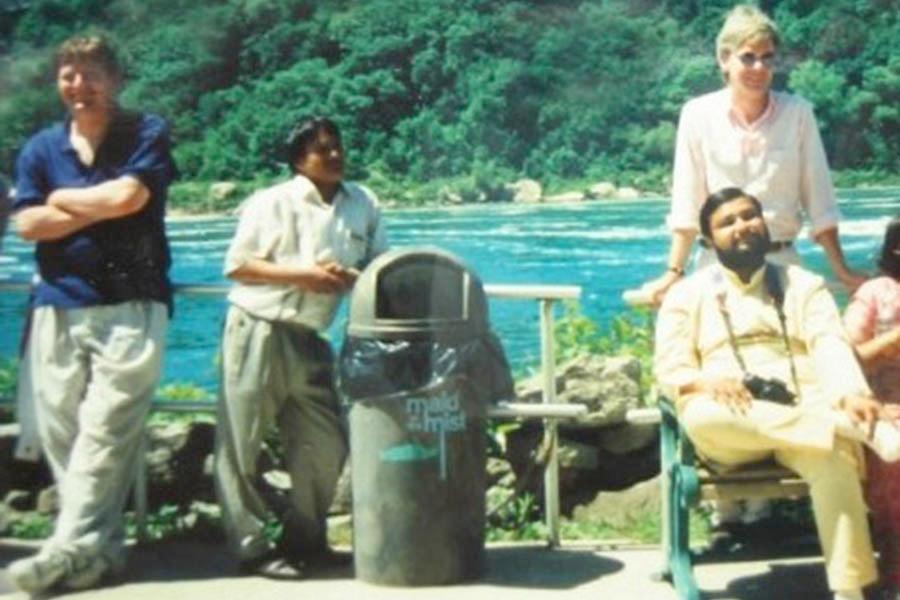 Brahmachari Girish Ji visiting Niagara Falls in May 1991. Behind Girish Ji is Mr. Sandy Tipton and left is Mr. Ken Krumpy with Mr. Ramdev next to him on right. 